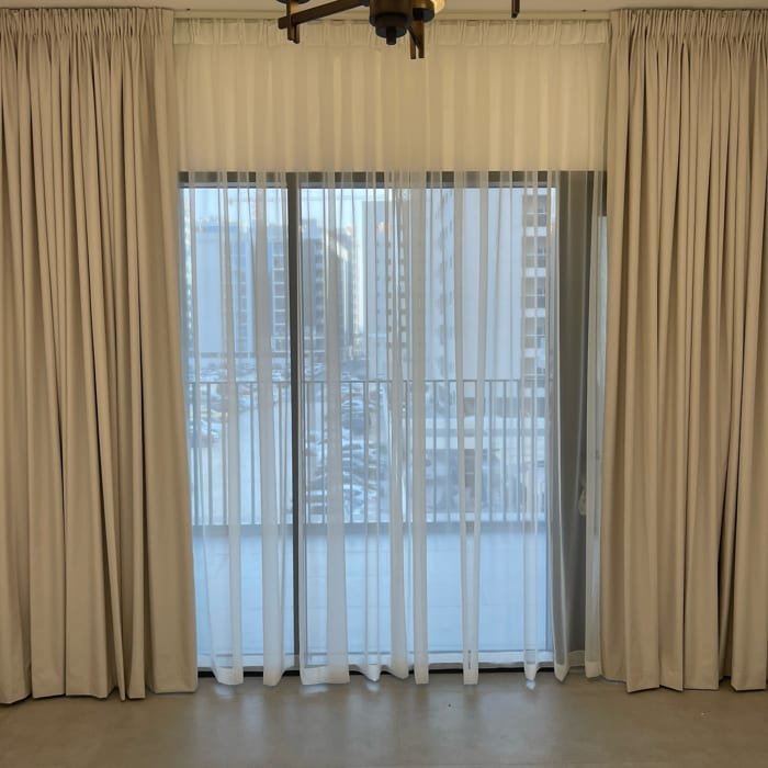 White Sheer Curtains Covering Balcony Glass Doors in Dubai Marina
